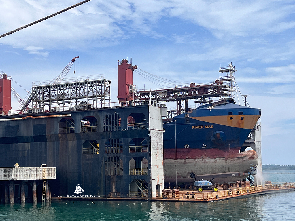 MV. River Mas in the floating dock before hull repainting at PaxOcean Batam.